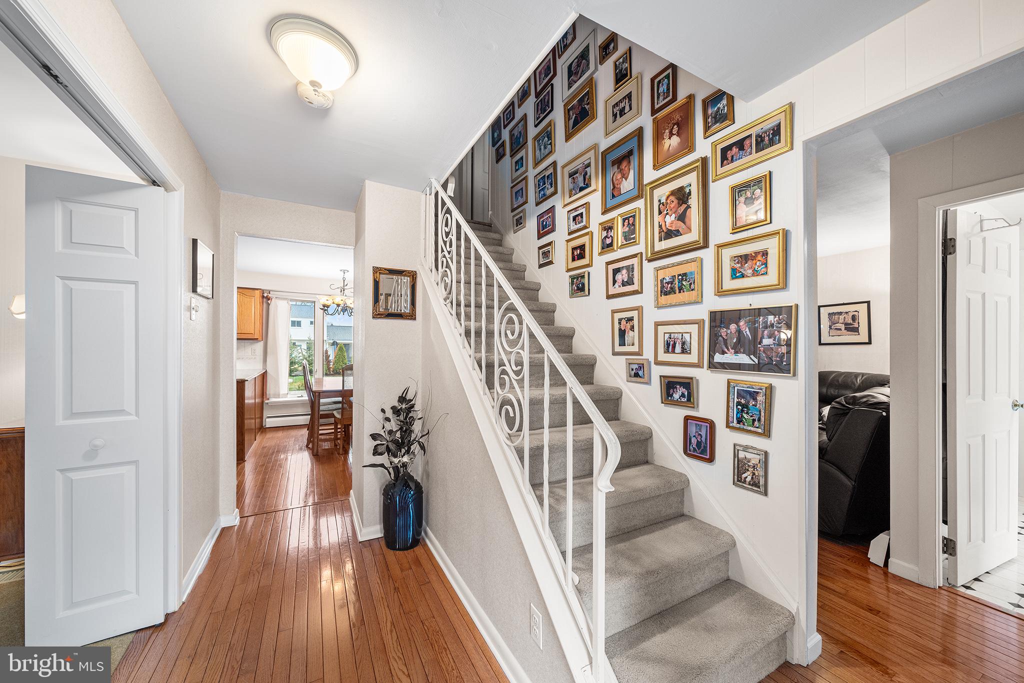 1571 Carousel Drive Warminster, PA 18974 - Photo 4 of 40 a view of staircase with lots of frames on wall and wooden floor