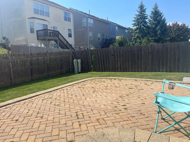 a view of a chairs and bench in the backyard