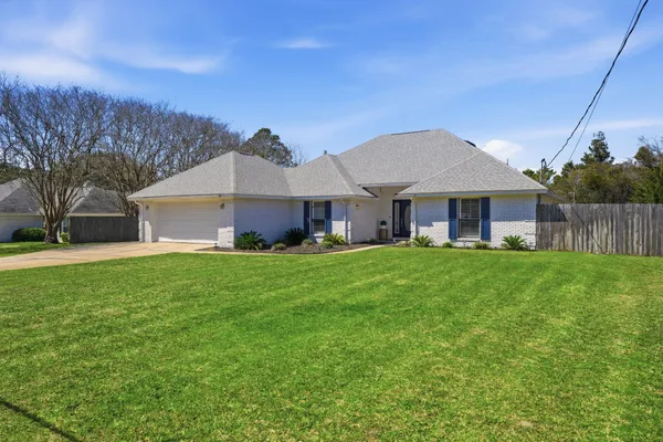 a front view of a house with a garden