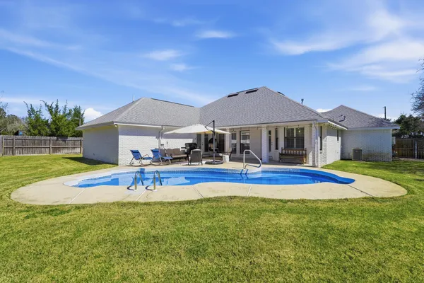 a view of a swimming pool with a lounge chairs