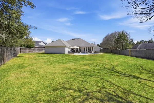 a front view of a house with a yard and trees