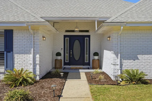a front view of a house with garden