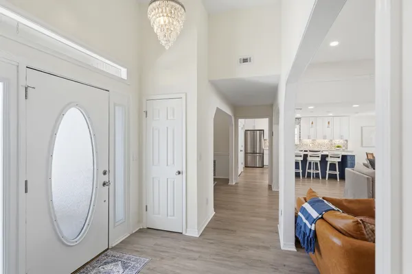 a living room with furniture kitchen and a table