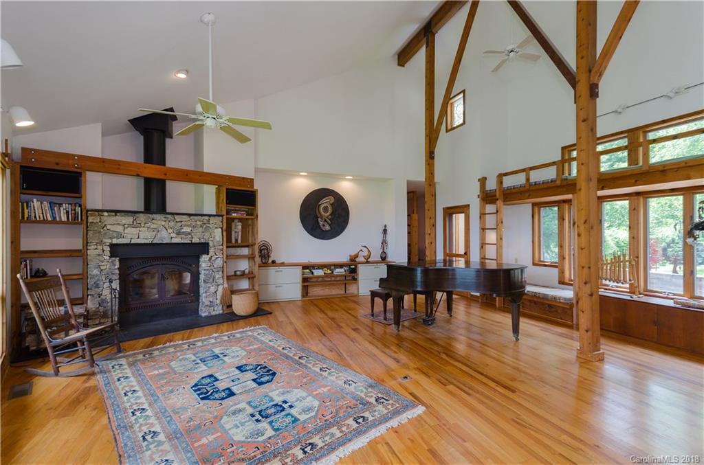 670 Run Away Ridge Clyde, NC 28721 - Photo 3 of 24 a living room with furniture a rug and a fireplace