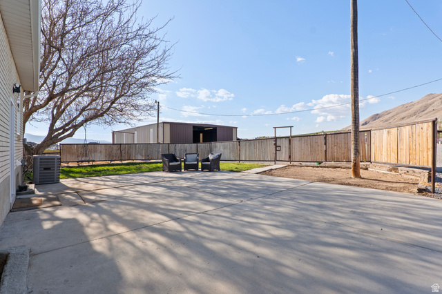 115 East 1600th Street North Santaquin, UT 84655 - Photo 48 of 52 Spacious concrete patio and a grassy yard area, defined by a wood privacy fence