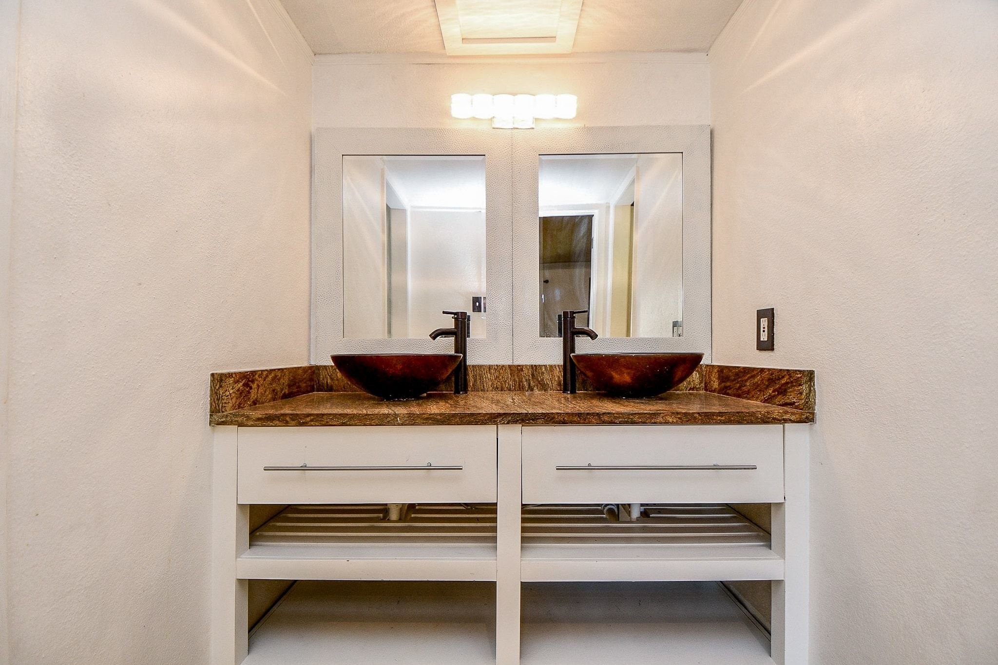 6000 Inwood Drive, Unit 1 Houston, TX 77057 - Photo 24 of 29 a bathroom with a granite countertop sink and a mirror