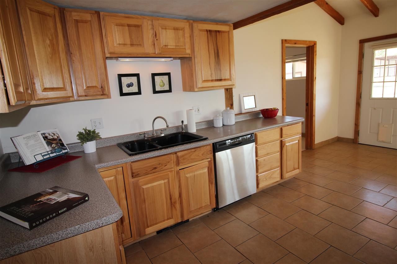 3393 F Road Clifton, CO 81520 - Photo 8 of 30 a kitchen with stainless steel appliances granite countertop a sink stove and cabinets
