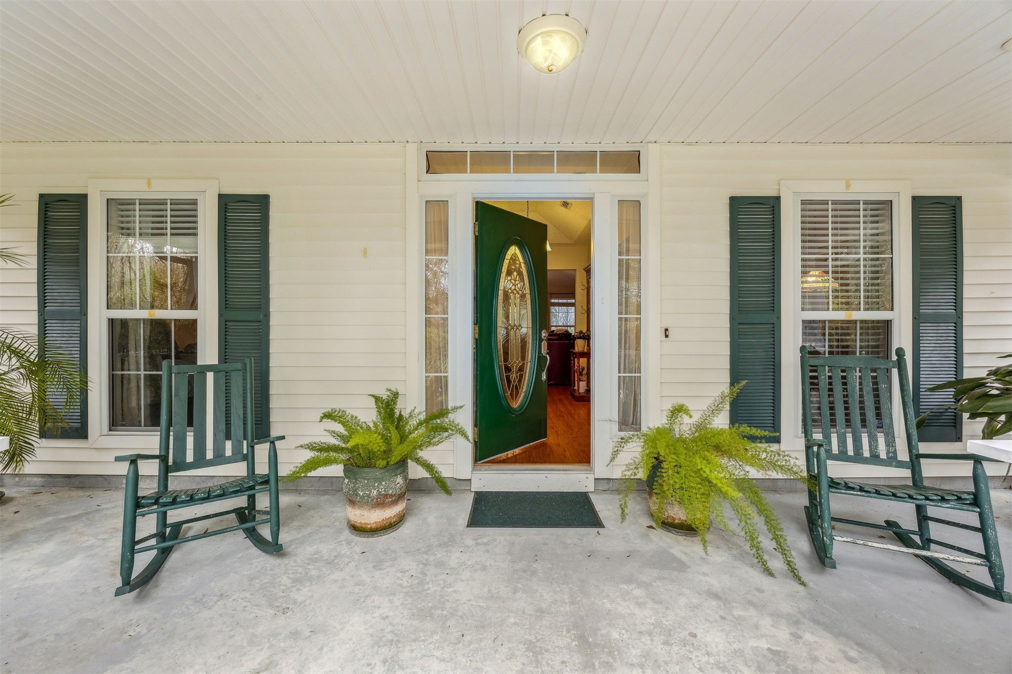 86341 Meadowfield Bluffs Road Yulee, FL 32097 - Photo 11 of 68 a view of a entryway door of the house with outdoor seating