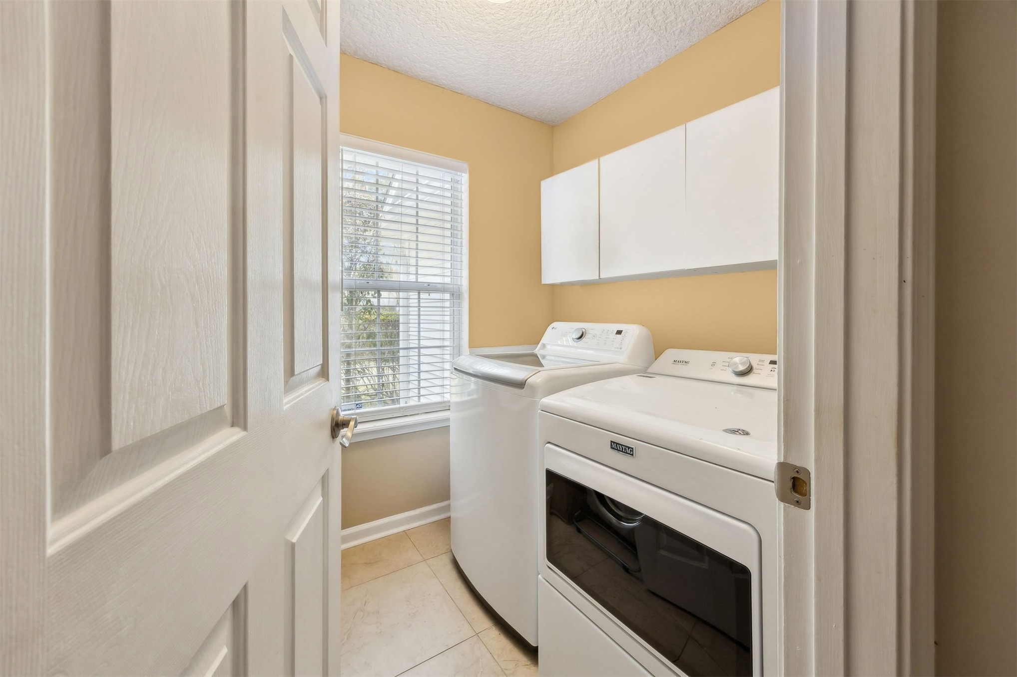 86341 Meadowfield Bluffs Road Yulee, FL 32097 - Photo 21 of 68 a view of washer and dryer with bathroom in the background