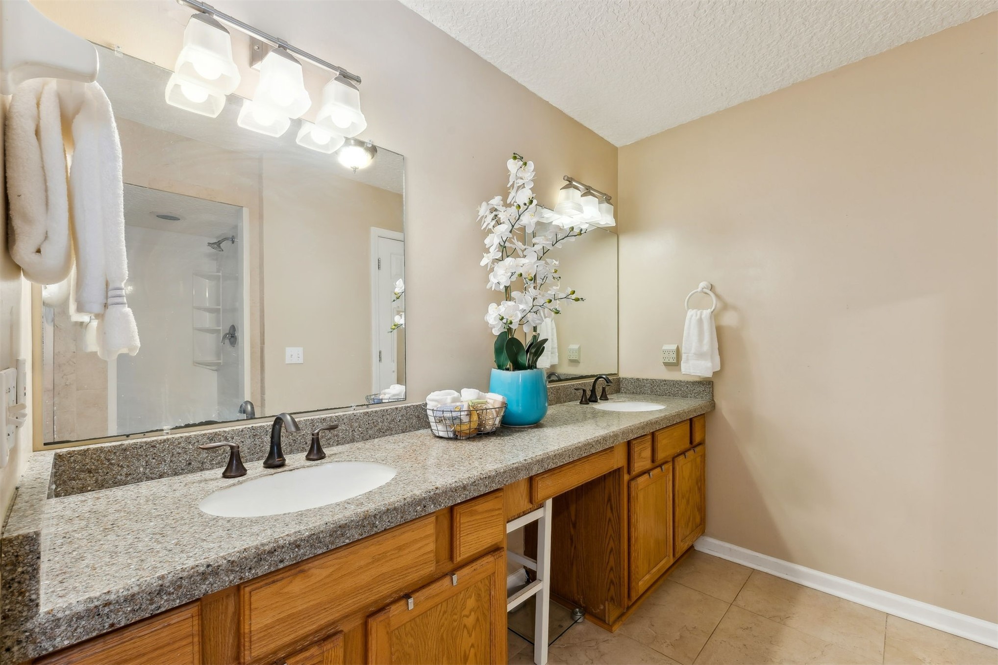86341 Meadowfield Bluffs Road Yulee, FL 32097 - Photo 23 of 68 a bathroom with a granite countertop sink a mirror and a shower