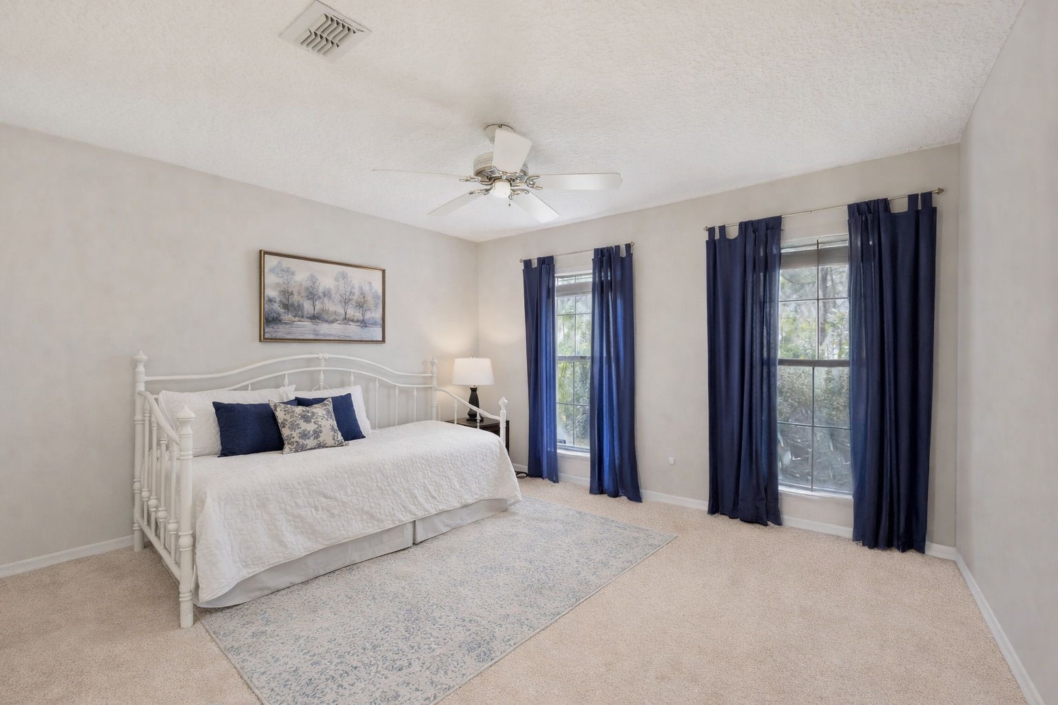 86341 Meadowfield Bluffs Road Yulee, FL 32097 - Photo 27 of 68 a bedroom with a large bed and a chandelier