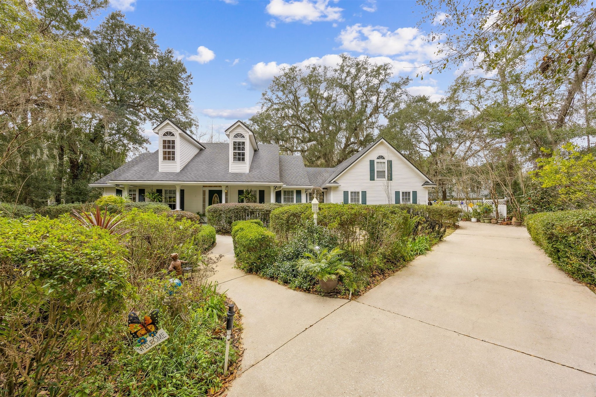 86341 Meadowfield Bluffs Road Yulee, FL 32097 - Photo 9 of 68 a front view of a house with a yard and trees