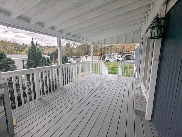 a view of balcony with wooden floor
