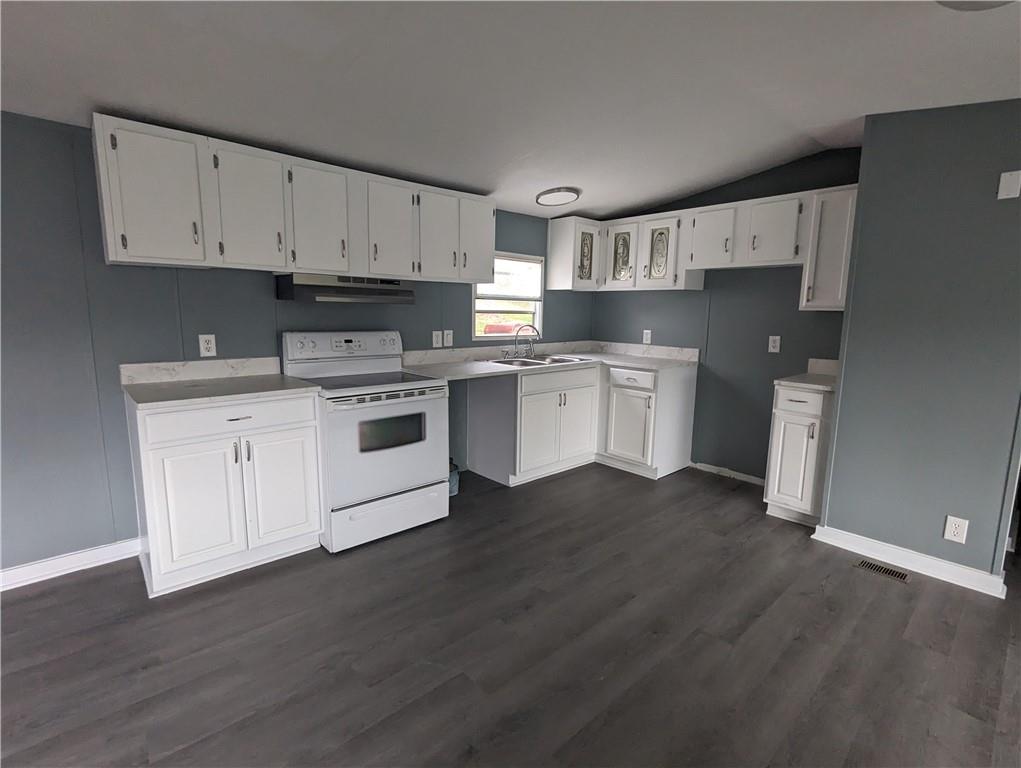 514 Reed Circle Ruffs Dale, PA 15679 - Photo 4 of 19 a kitchen with stainless steel appliances white cabinets and wooden floor