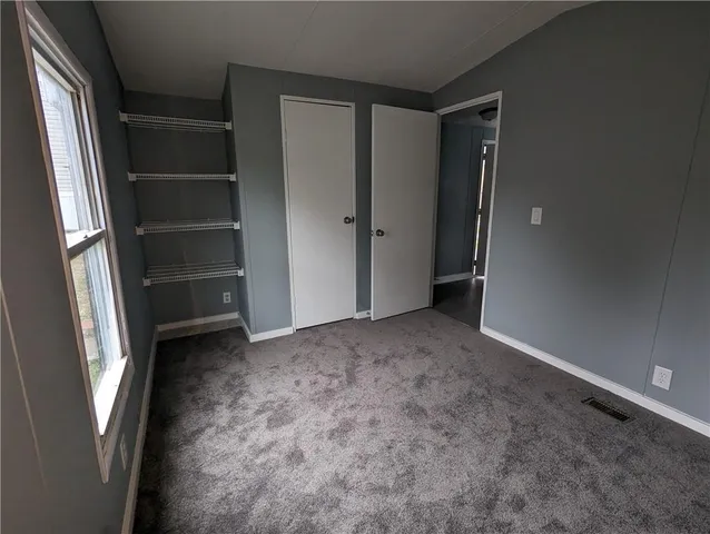 a view of an empty room with a closet