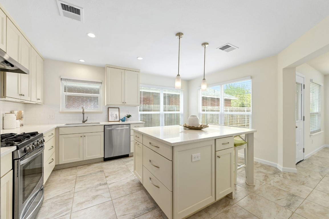 a kitchen with appliances cabinets and a sink