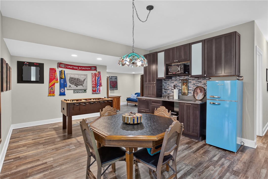321 High Hampton Road Salem, SC 29676 - Photo 22 of 46 Rich wood-look flooring and dark cabinetry anchor this versatile lower-level recreation space.