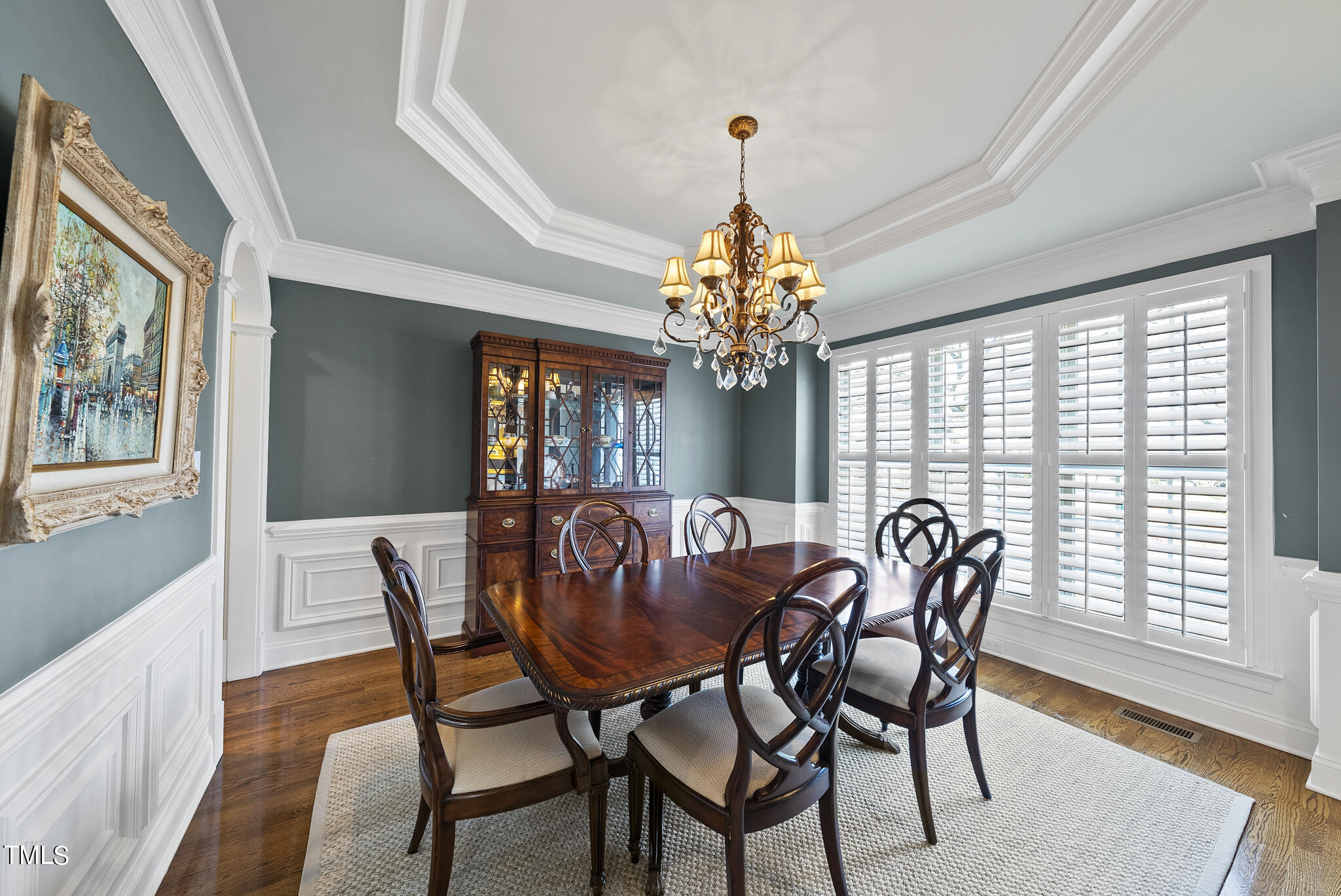 1202 Ileagnes Road Raleigh, NC 27603 - Photo 3 of 53 a view of a dining room with furniture a chandelier and wooden floor