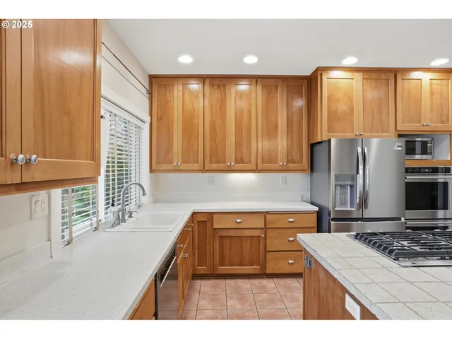 a kitchen with a stove a sink and a refrigerator