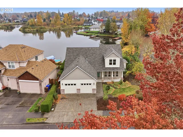 an aerial view of a house with a lake view