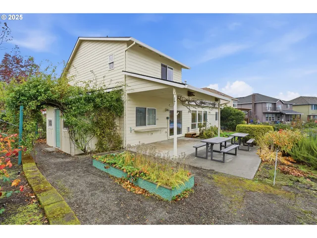 a view of a house with backyard and sitting area