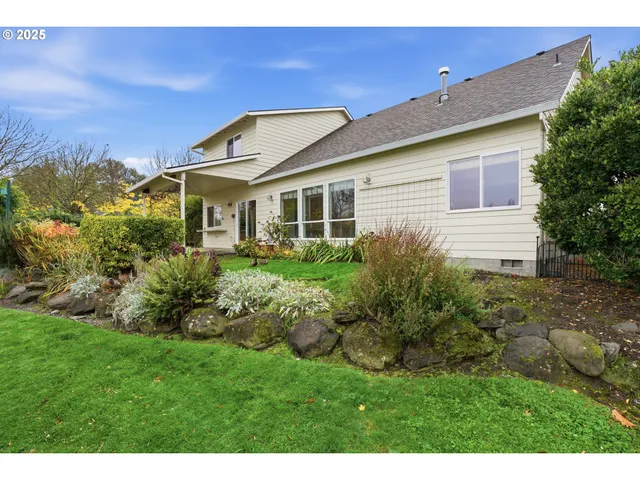 a front view of house with a garden