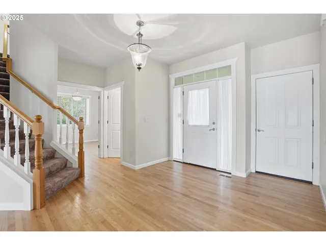 a view of an entryway with wooden floor