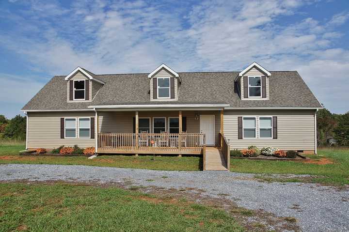 4825 Deer View Road Gretna, VA 24557 - Photo 2 of 23 a front view of a house with garden