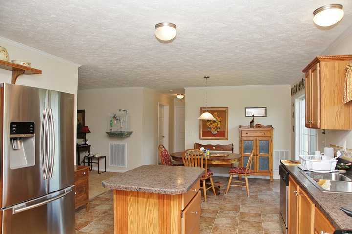 4825 Deer View Road Gretna, VA 24557 - Photo 11 of 23 a kitchen with stainless steel appliances granite countertop sink refrigerator and cabinets