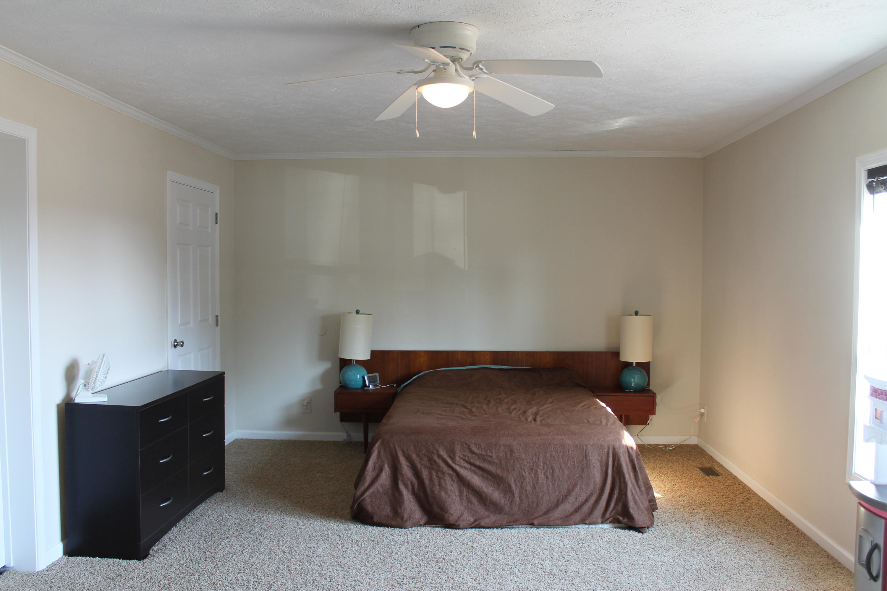 4825 Deer View Road Gretna, VA 24557 - Photo 12 of 23 a bedroom with a bed and a chandelier