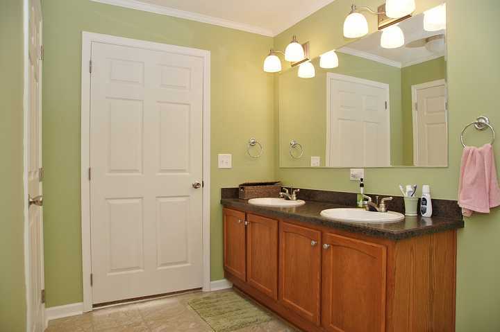 4825 Deer View Road Gretna, VA 24557 - Photo 14 of 23 a bathroom with a granite countertop sink and a mirror