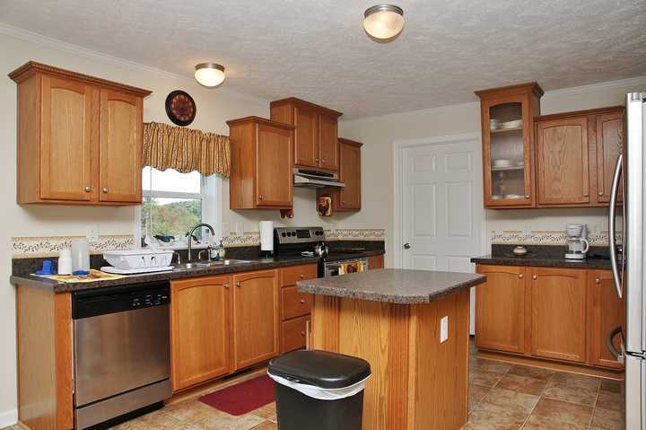 4825 Deer View Road Gretna, VA 24557 - Photo 9 of 23 a kitchen with stainless steel appliances granite countertop a sink stove and cabinets