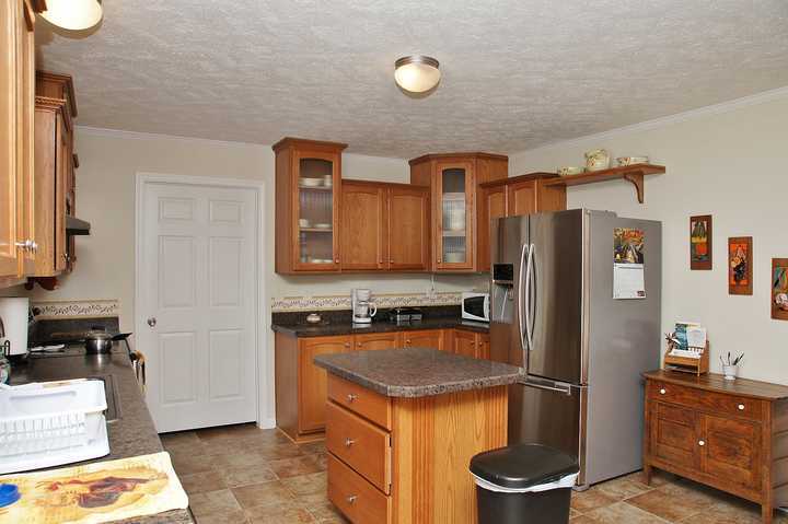 4825 Deer View Road Gretna, VA 24557 - Photo 10 of 23 a kitchen with stainless steel appliances granite countertop a refrigerator a stove a sink and a stove