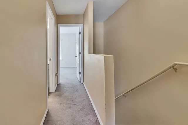 a view of a hallway with a white walls