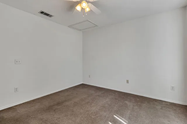 an empty room with a fan