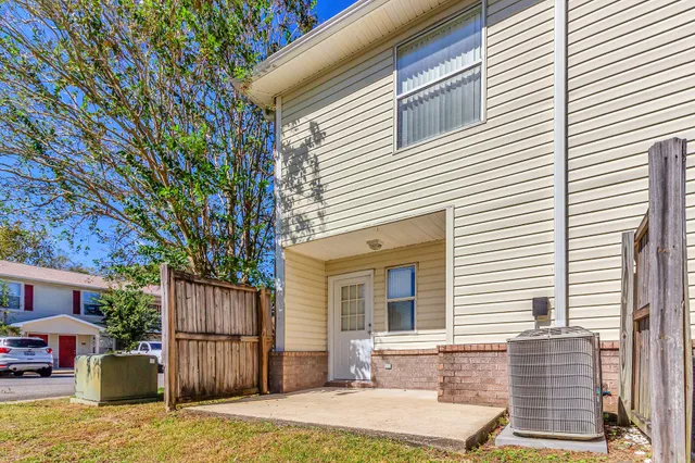 a backyard of a house with yard and outdoor seating