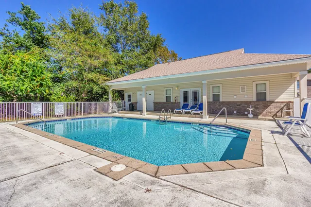 a view of a swimming pool with chairs