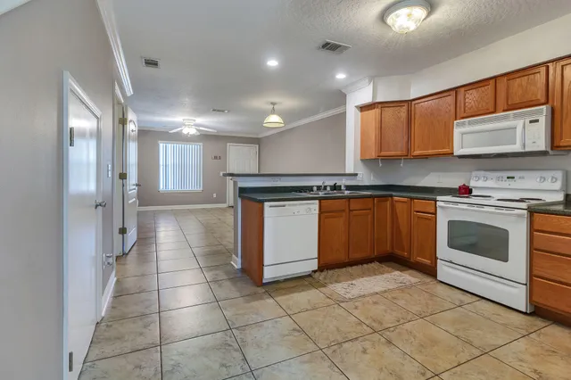 a kitchen with a stove a sink and a refrigerator
