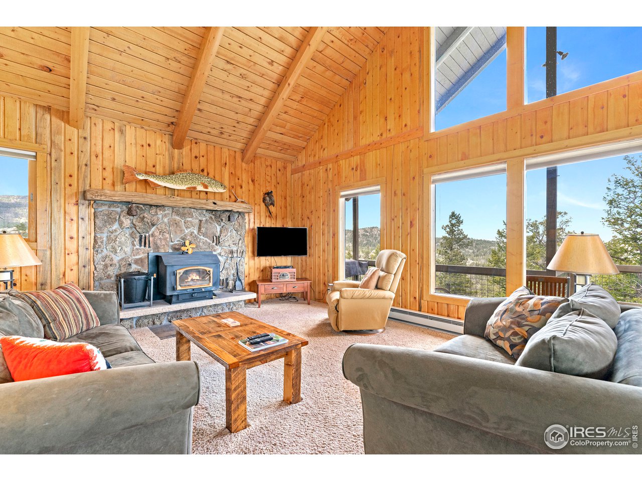 1359 Crow Road Red Feather Lakes, CO 80545 - Photo 5 of 23 Moss rock fire place with wood stove insert.