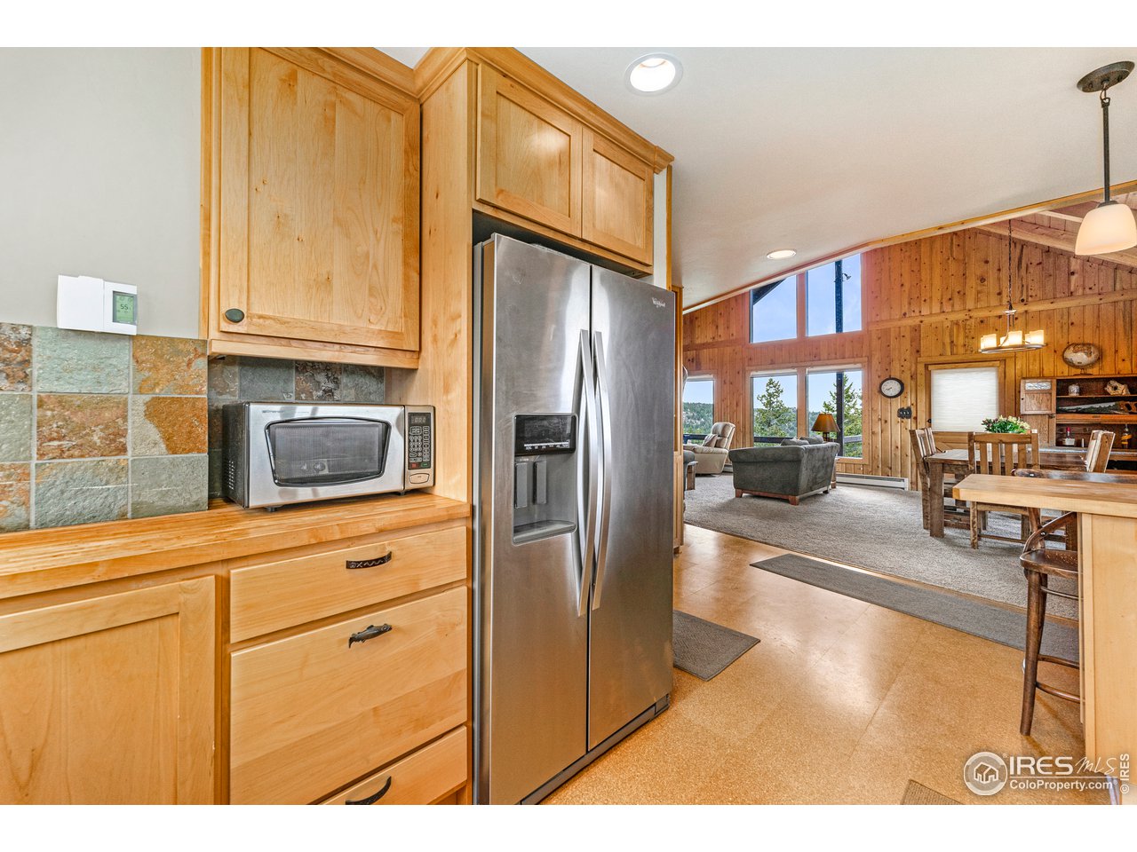 1359 Crow Road Red Feather Lakes, CO 80545 - Photo 10 of 23 Recessed lighting, crown molding, country cabinets, stainless appliances.