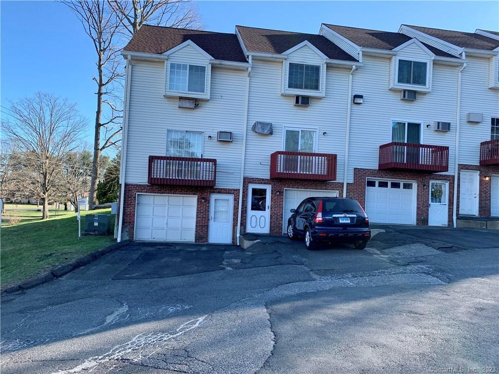 66 Wakelee Road, Unit 2 Waterbury, CT 06705 - Photo 1 of 1 a car parked in front of a house