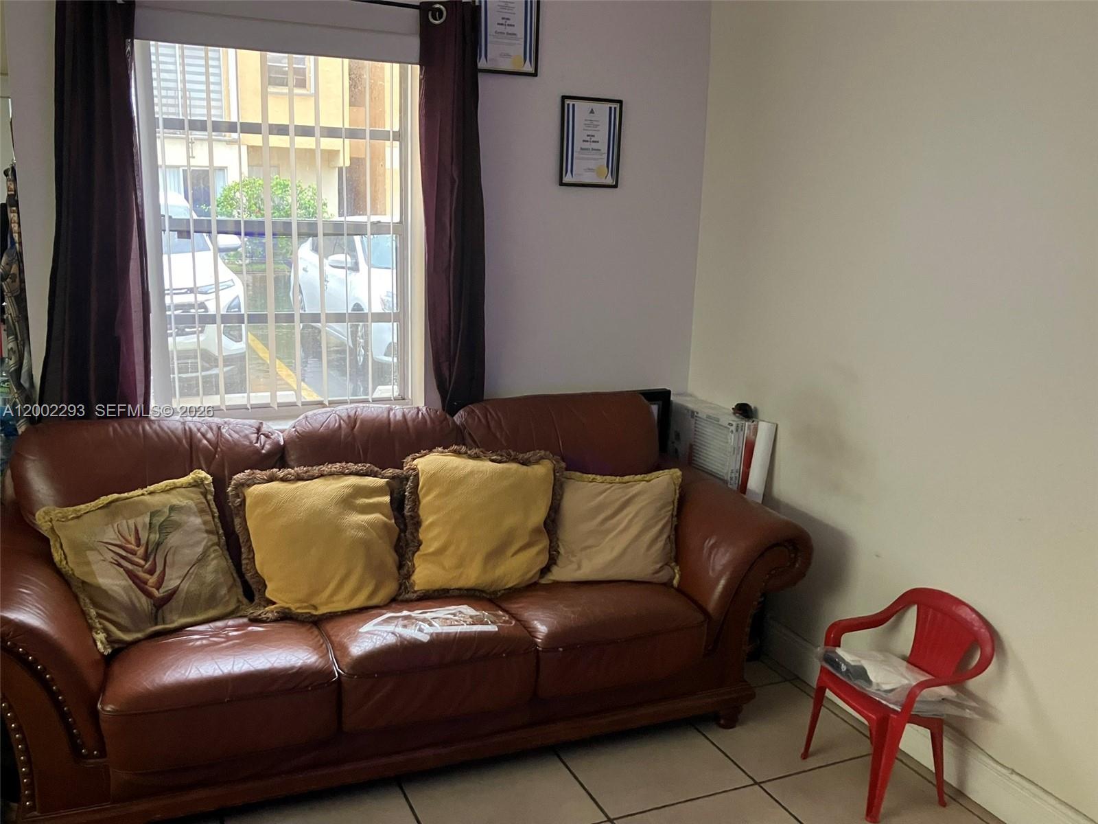 9311 Southwest 4th Street, Unit 104B Miami, FL 33174 - Photo 2 of 21 a living room with a couch and a window