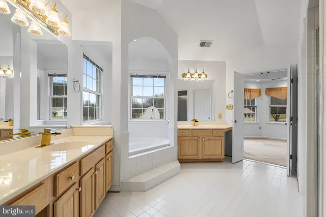a bathroom with a sink a vanity and a window