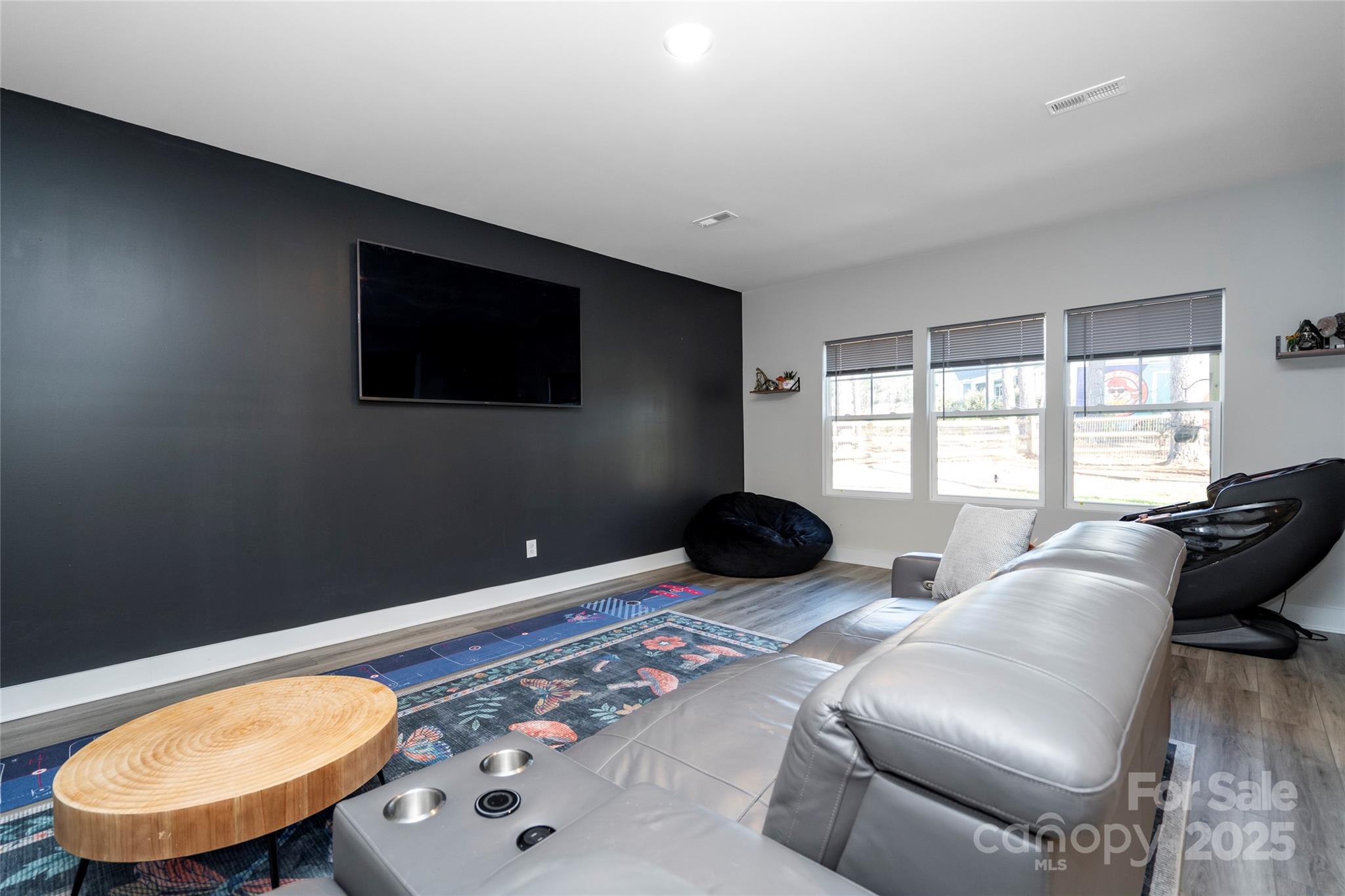 17359 Huntersville-Concord Road Huntersville, NC 28078 - Photo 16 of 41 a living room with a bed furniture and a flat screen tv
