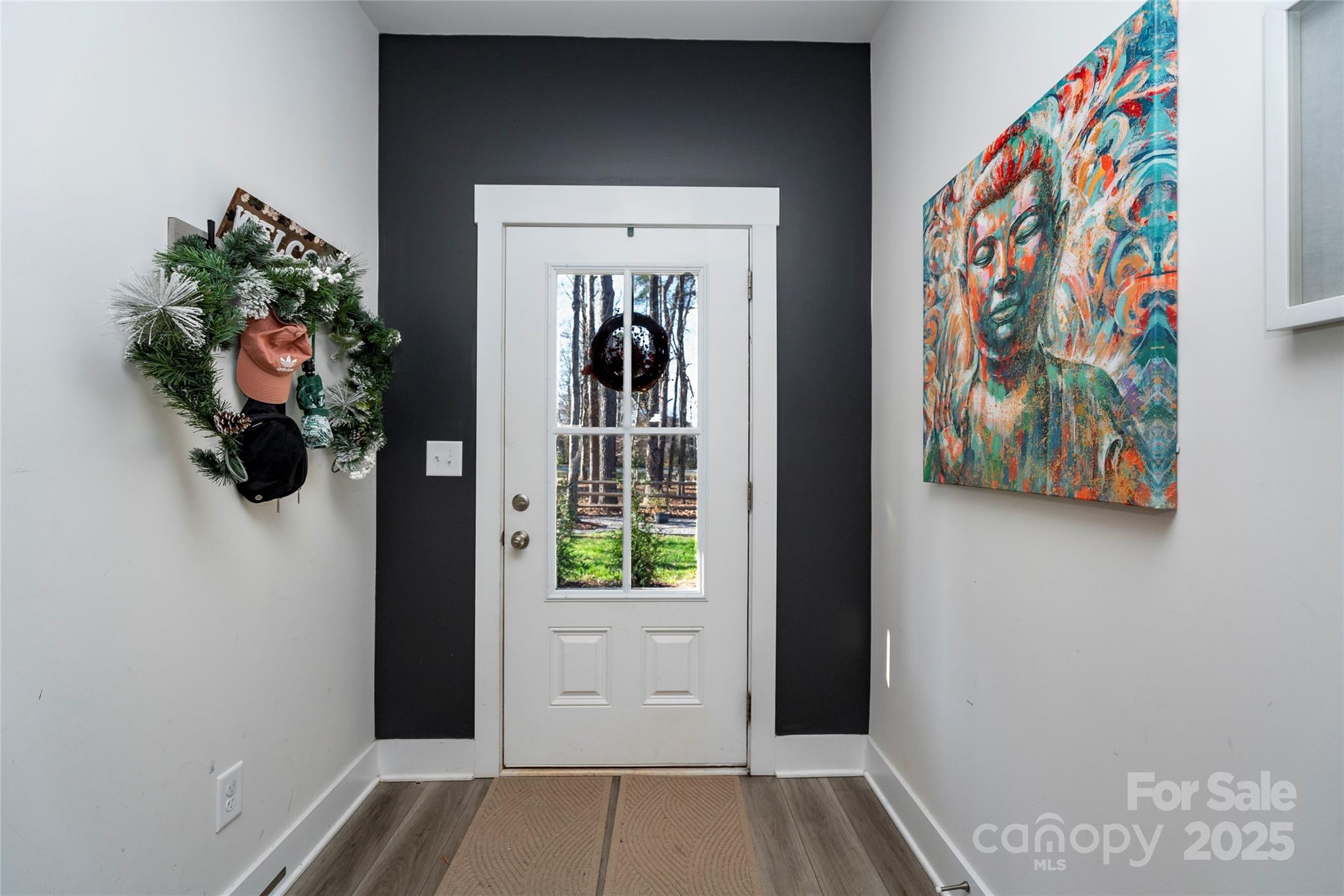 17359 Huntersville-Concord Road Huntersville, NC 28078 - Photo 5 of 41 a view of a hallway with wooden floor and a painting on the wall