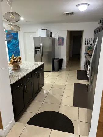 a kitchen with stainless steel appliances granite countertop a sink dishwasher and a granite counter top