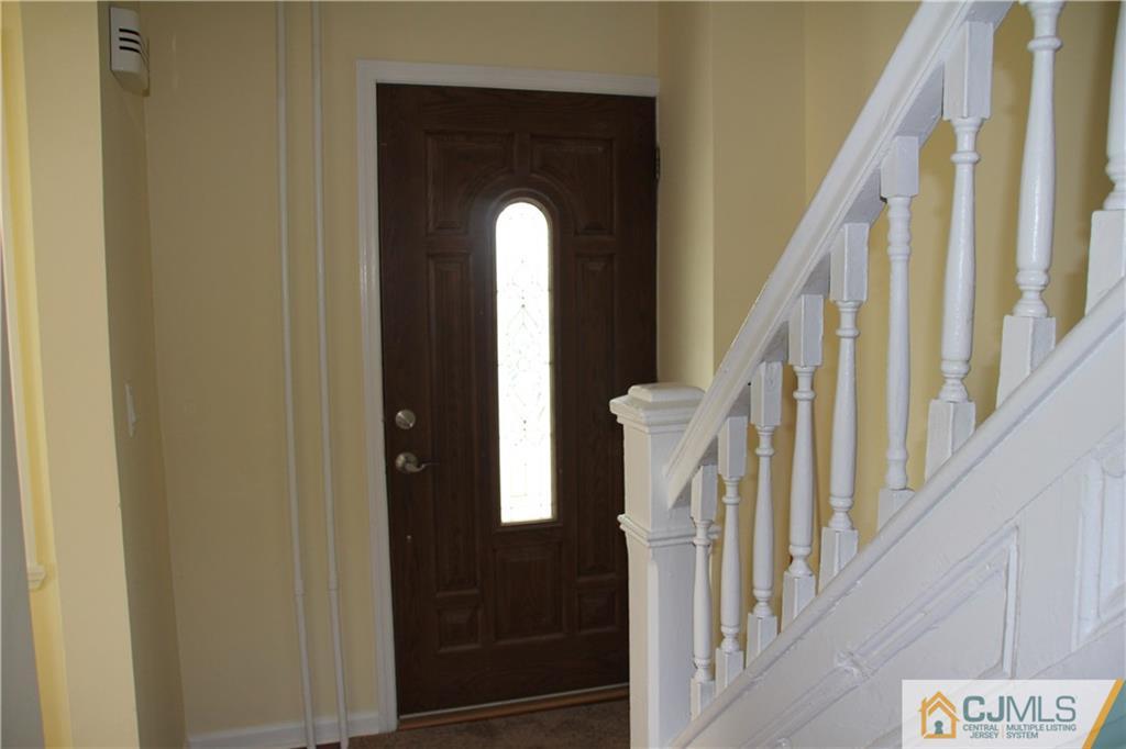522 Front Street Dunellen, NJ 08812 - Photo 12 of 24 a view of staircase with railing and a chandelier