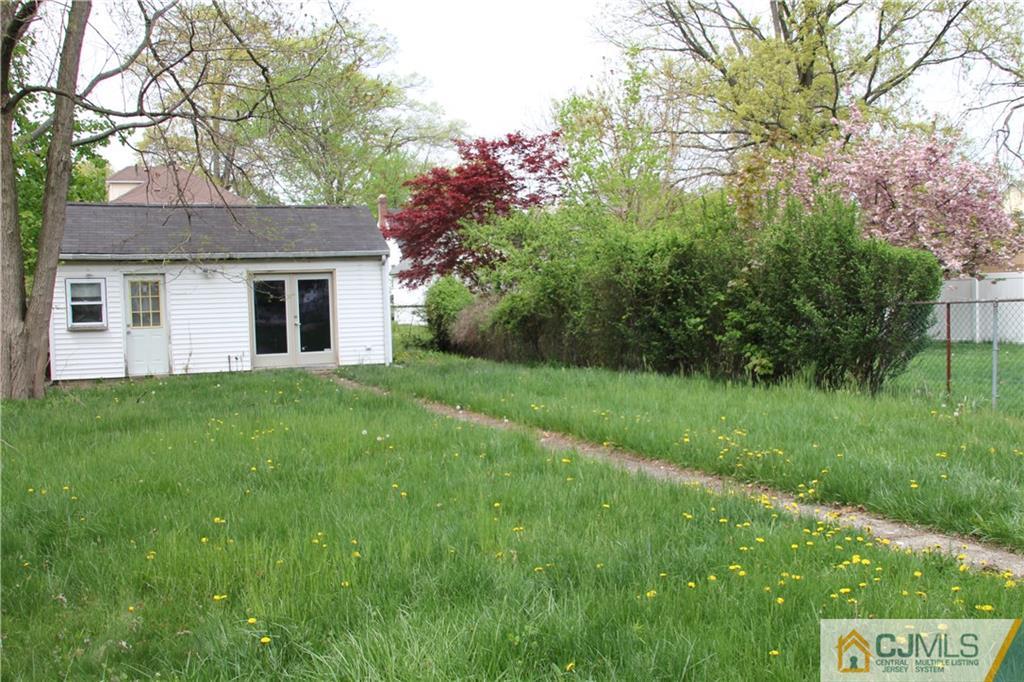 522 Front Street Dunellen, NJ 08812 - Photo 21 of 24 a backyard of a house with plants and large tree