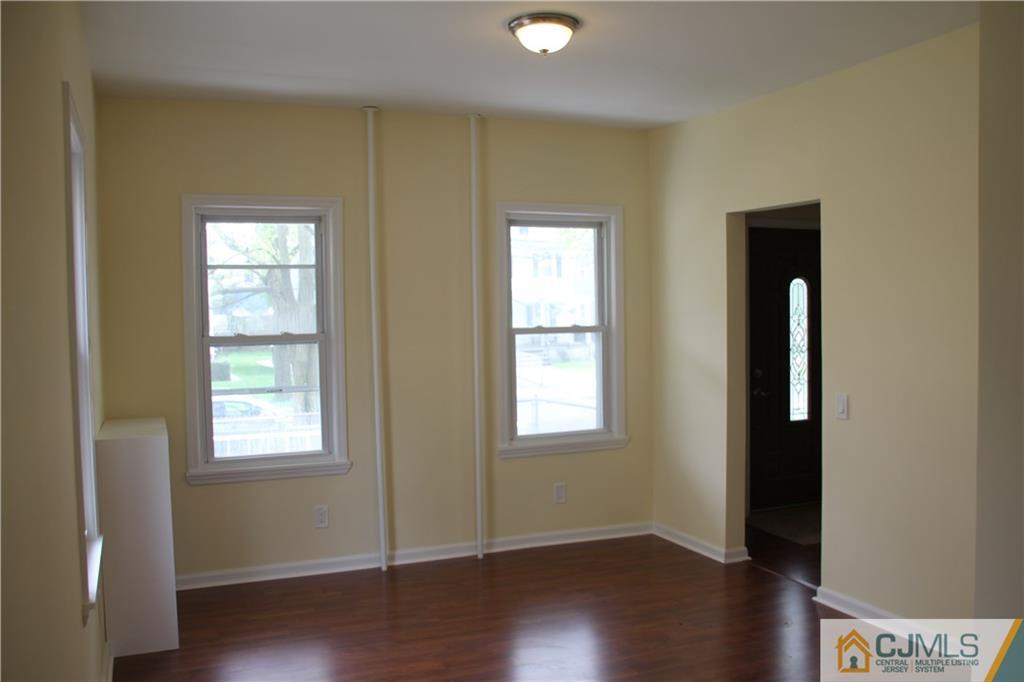 522 Front Street Dunellen, NJ 08812 - Photo 8 of 24 an empty room with wooden floor and windows