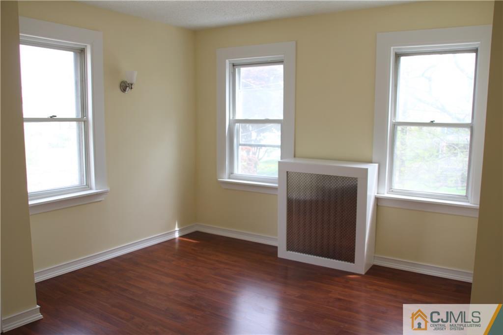 522 Front Street Dunellen, NJ 08812 - Photo 10 of 24 a view of an empty room with wooden floor and a window